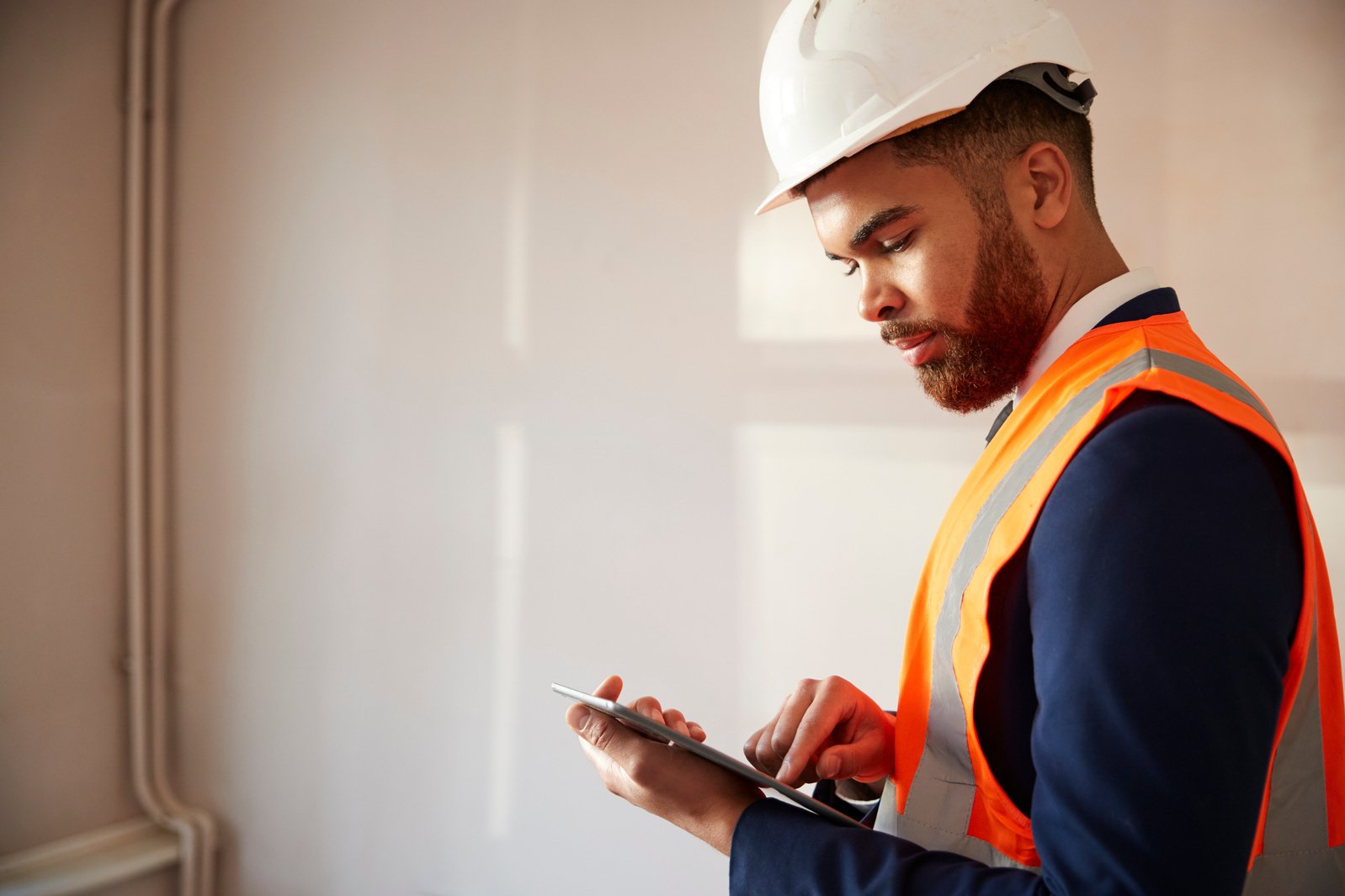 Surveyor in Hard Hat and High Visibility Jacket with Digital Tab